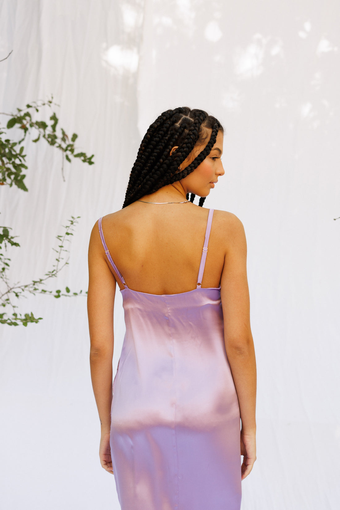 Maria wears a silk purple dress