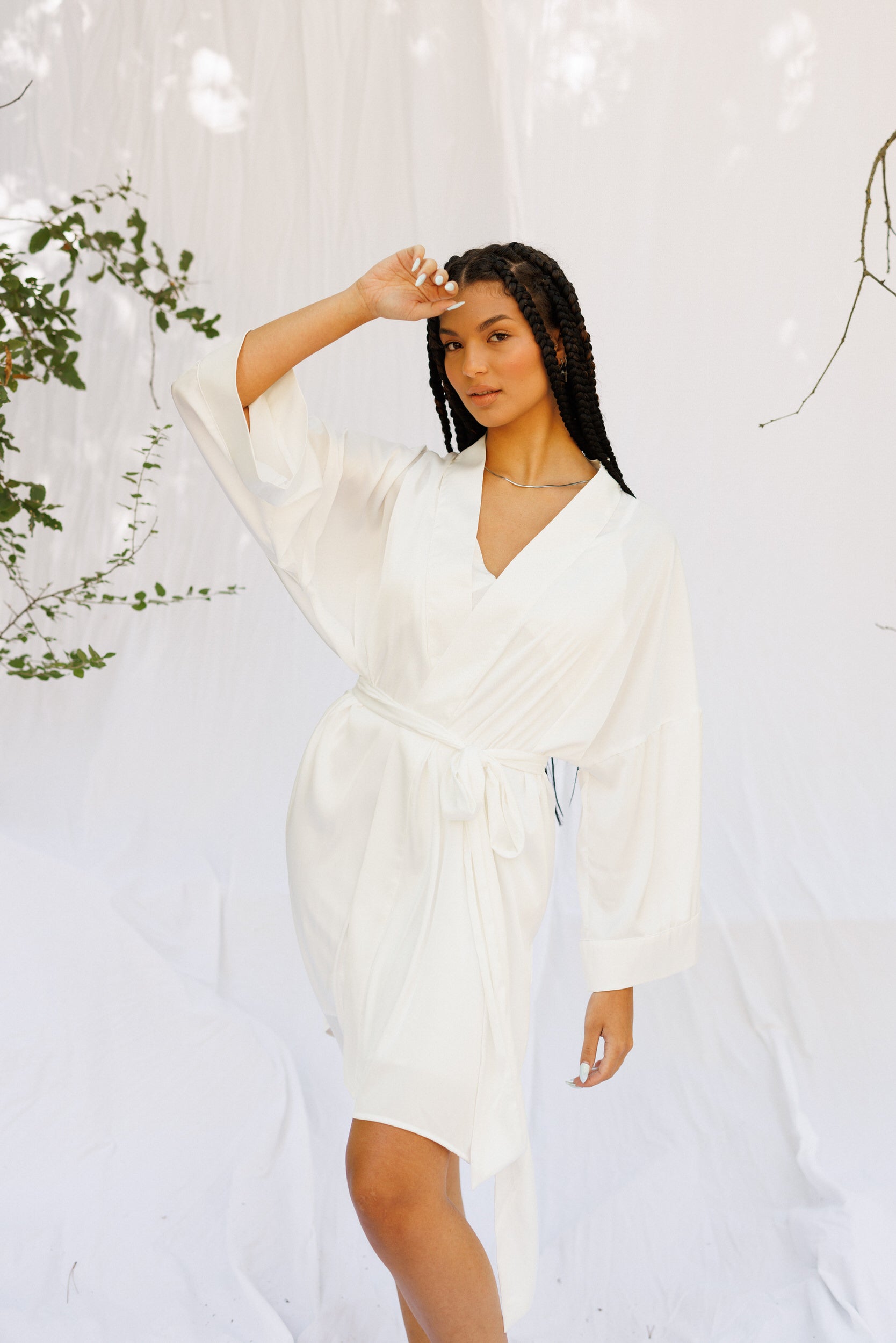 Model takes a pose in a white robe