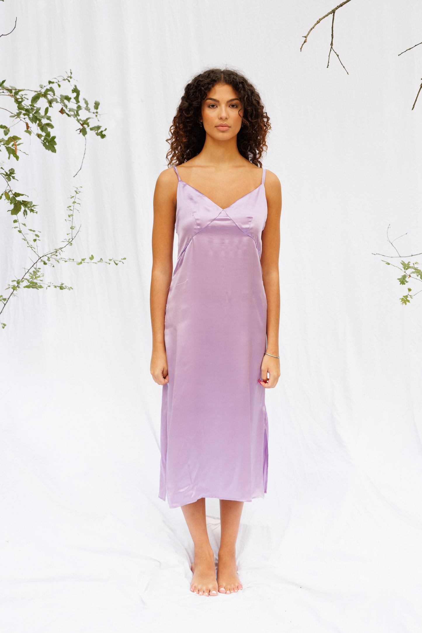 Front image of Maria in a purple slip dress calf length 