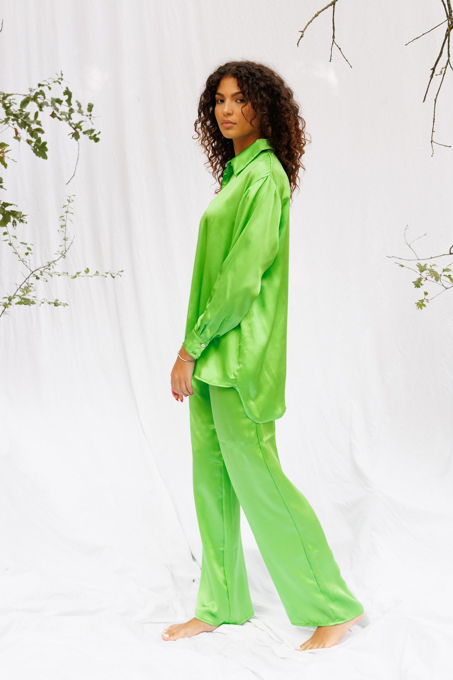 Maria walking around and wearing green silk set