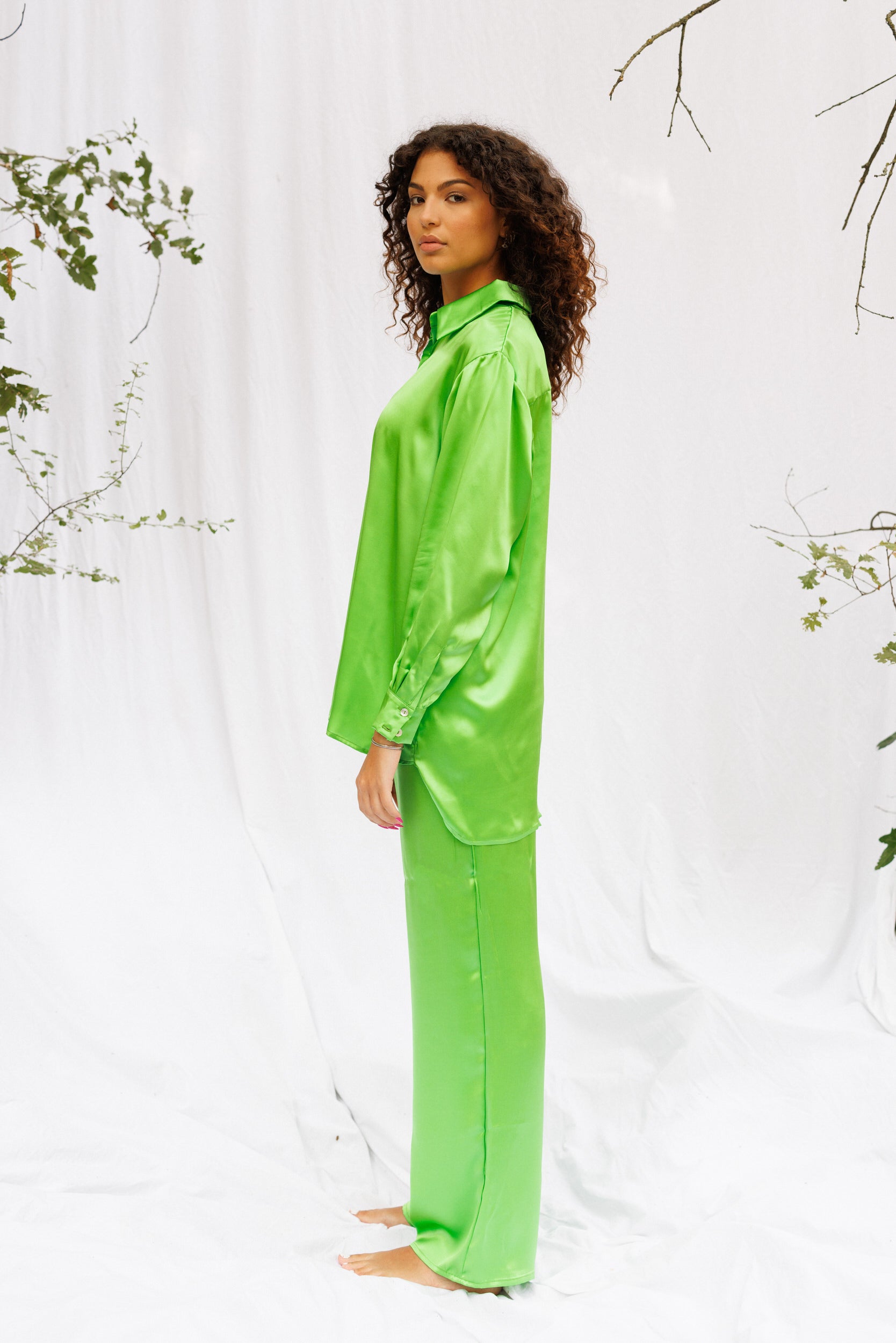 Side image of Maria wearing green silk set