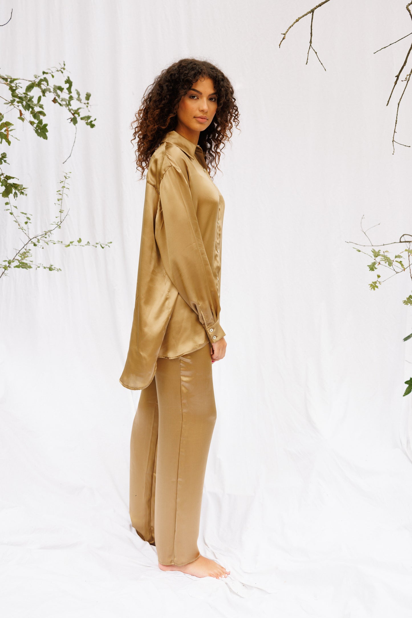 Model wears brown-gold silk set 